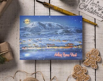 May include: A Christmas card featuring a snowy mountain landscape with a village at the base. The card has the text "Nollaig Shona Dhuit" and is surrounded by gingerbread cookies and festive decorations.
