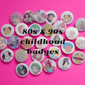 May include: A collection of 80s and 90s childhood badges featuring cartoon characters and designs. The badges are round and colorful, with a variety of themes, including animals, toys, and television shows.