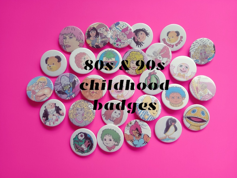 May include: A collection of 80s and 90s childhood badges featuring cartoon characters and designs. The badges are round and colorful, with a variety of themes, including animals, toys, and television shows.