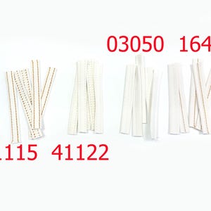 May include: Four groups of white fabric strips arranged on a white background. The groups are labeled with red text: 41115, 41122, 03050, and 16494. Each group contains several narrow, rectangular white textile pieces with visible stitching details.