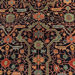 May include: A detailed rug with a repeating geometric pattern in shades of red, orange, blue, and green on a dark blue background.