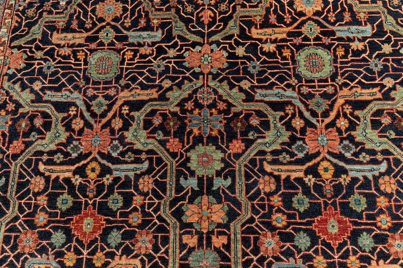 May include: A detailed rug with a repeating geometric pattern in shades of red, orange, blue, and green on a dark blue background.