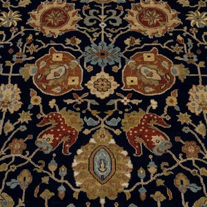May include: A dark blue rug with a traditional Persian design featuring intricate floral patterns in shades of brown, beige, and blue.