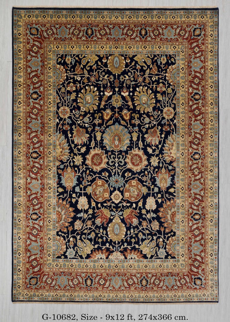 May include: A traditional Persian rug with a navy blue background and intricate floral patterns in shades of gold, red, and cream. The rug has a wide border with a repeating design. G-10682, Size - 9x12 ft, 274x366 cm.
