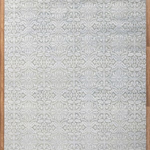 May include: A light gray area rug with a white floral pattern. The rug has a fringe border and measures 8x10 feet, or 250x300 centimeters. Item Code: 7063