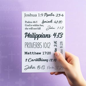 May include: A white card with black text listing various Bible verses. The verses include Joshua 1:9, Psalm 23:4, Psalms 46:5, Isaiah 41:10, John 1:12, Philippians 4:13, Proverbs 10:12, Matthew 17:20, 2 Corinthians 12:10, John 15:13, and Psalm 31:24.
