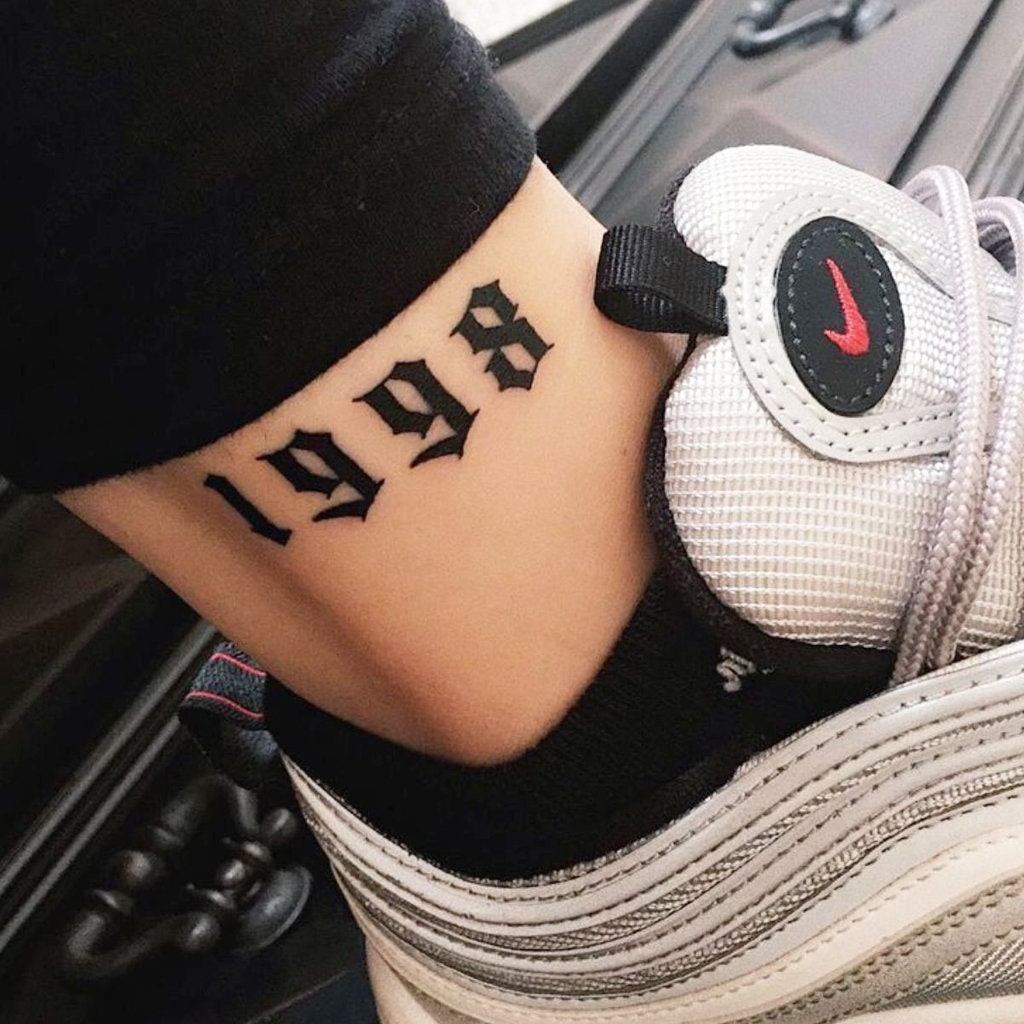 Numbers 5462 tattooed on the left hands fingers  Tattoos Finger tattoos  Knuckle tattoos