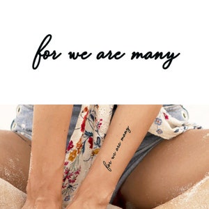 May include: A temporary tattoo with the text "for we are many" applied to a person's arm.