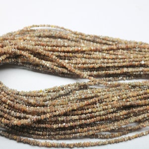 May include: A strand of brown and clear rough diamond beads. The beads are small and irregular in shape, and they are strung on a thin wire.