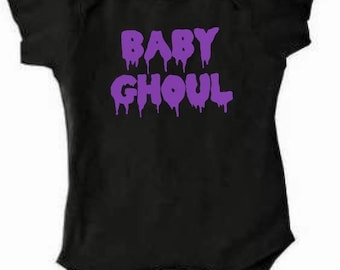 May include: Black baby onesie with purple dripping text that reads "BABY GHOUL".