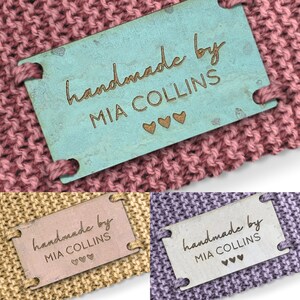 Peut inclure: Trois échantillons de tissu différents avec une étiquette en bois cousue sur chacun. L'étiquette est bleu clair, beige et blanche. L'étiquette indique "handmade by MIA COLLINS" avec trois petits cœurs.