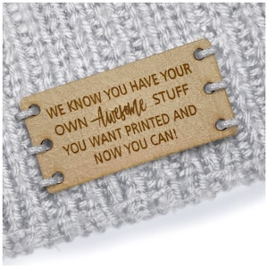 May include: A brown leather tag with the text "WE KNOW YOU HAVE YOUR OWN Awesome STUFF YOU WANT PRINTED AND NOW YOU CAN!" printed on it.