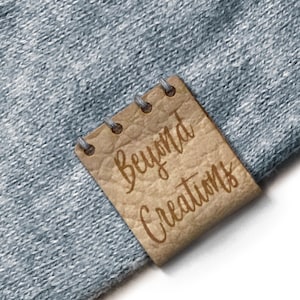 May include: A brown leather tag with the text "Beyond Creations" written in a cursive font.