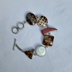 Silver bracelet with shells, coral, Shiva eye