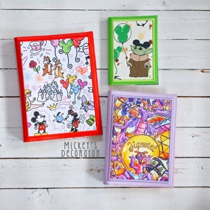 May include: Three colorful notebooks with different designs. The first notebook has a red border and features a white background with Mickey Mouse, Minnie Mouse, and other Disney characters. The second notebook has a green border and features a green background with a character from Star Wars. The third notebook has a purple border and features a purple background with a character from the movie 'Fantasia'.