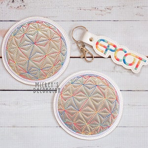 May include: Two white round coasters with a rainbow-colored embroidered design of the Epcot Spaceship Earth. A white keychain with the word "EPCOT" embroidered in rainbow colors.