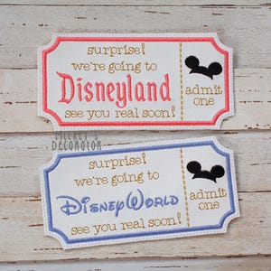 May include: Two embroidered fabric tickets. One reads "surprise! we're going to Disneyland see you real soon!" and the other "surprise! we're going to Disney WORLD see you real soon!". Each has a Mickey Mouse silhouette and "admit one".