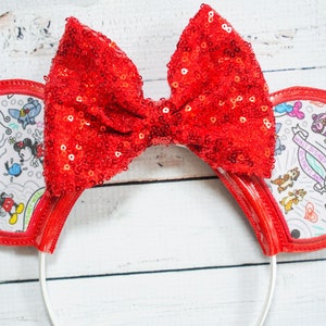 May include: Red sequin bow headband with white ears featuring a black and white doodle design of Mickey Mouse characters and the text "Walt Disney World".