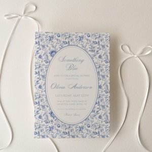 Peut inclure: Une invitation blanche avec un motif floral bleu et le texte "Something Blue" pour la fête de mariage d'Olivia Anderson le samedi 12 mai au Turtle Ranch.