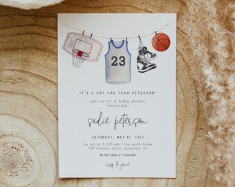 May include: A baby shower invitation with a basketball theme. The invitation features a basketball jersey with the number 23, a basketball, a basketball hoop, and a pair of sneakers. The text on the invitation reads "It's a boy for Team Peterson! Join us for a baby shower -honoring- Sadie Peterson. Saturday, May 17, 2025. Tip off at 3:00 pm | The Smith Home 129 Hotshot Court, Bozeman, MT. Registered at Amazon. RSVP to Jamie."