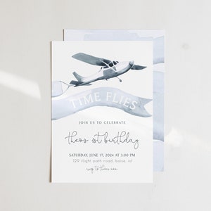May include: A blue and white watercolor invitation with a small airplane flying above a banner that reads "Time Flies". The invitation is for a first birthday party and includes the text "Theo's 1st Birthday", the date and time of the party, and the address.