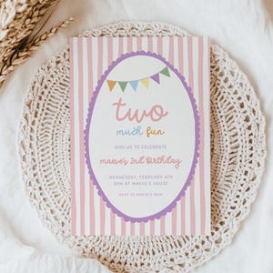 May include: A birthday invitation with pink and white stripes, featuring the text "two much fun." The invitation has a purple scalloped border and a banner of colorful flags. The text reads "maeve's 2nd birthday."