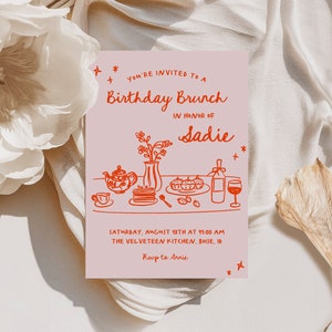 May include: A pink invitation card with red text and illustrations. The text reads "You're invited to a Birthday Brunch in honour of Sadie. Saturday, August 18th at 11:00 am. The Velveteen Kitchen, Boise, ID. RSVP to Annie."