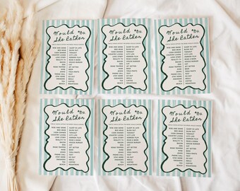 May include: Six teal and white striped cards with the text "Would She Rather" in a decorative font. Each card lists various choices for a game. The cards are arranged on a white surface with dried floral accents.