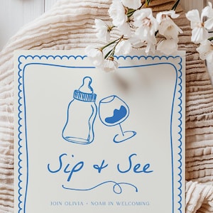 May include: A white card with a blue border and a blue illustration of a baby bottle and a wine glass. The text "Sip & See" is written in blue cursive. The text "Join Olivia & Noah in welcoming" is written in blue at the bottom of the card.