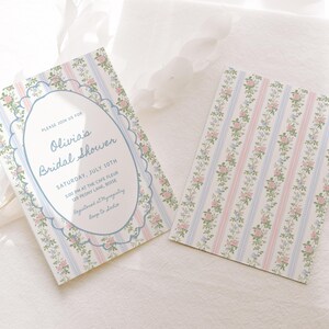 May include: A blue and white striped bridal shower invitation with a floral pattern and a scalloped border. The invitation reads "Please join us for Olivia's Bridal Shower" and includes the date, time, and location of the event.