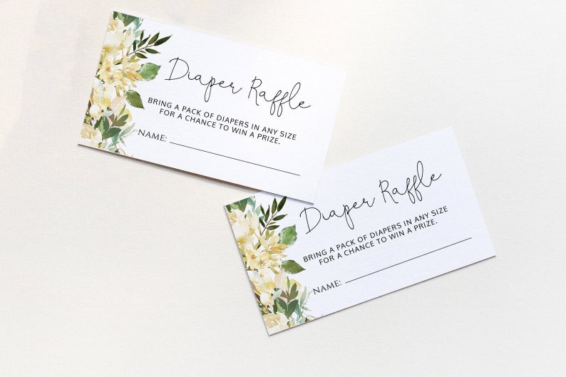 May include: Two white cards with green and yellow floral designs. The text on the cards reads "Diaper Raffle" and "Bring a pack of diapers in any size for a chance to win a prize." There is a blank line for a name on each card.