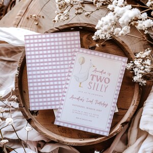 May include: Pink and white gingham patterned invitation with a cartoon goose illustration. The text reads "Amelia is Two Silly" and includes details for Amelia's 2nd birthday party.