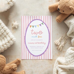 May include: A birthday invitation with a pink and white striped background. The invitation has a purple oval frame with the words "two much fun" and "Maeve's 2nd Birthday". The invitation is surrounded by a teddy bear, a star, and a knitted blanket.