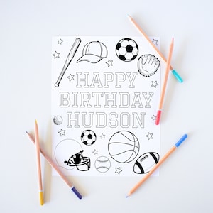 May include: A black and white coloring page with a sports theme. The page features a baseball bat, baseball, football, basketball, soccer ball, baseball glove, and a baseball helmet. The text on the page reads "Happy Birthday Hudson".