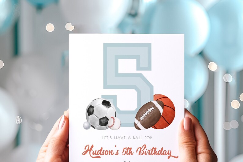 May include: A birthday card featuring a large number 5 in light blue, with illustrations of a soccer ball, baseball, football, and basketball. The text reads "Let's have a ball for Hudson's 5th Birthday."