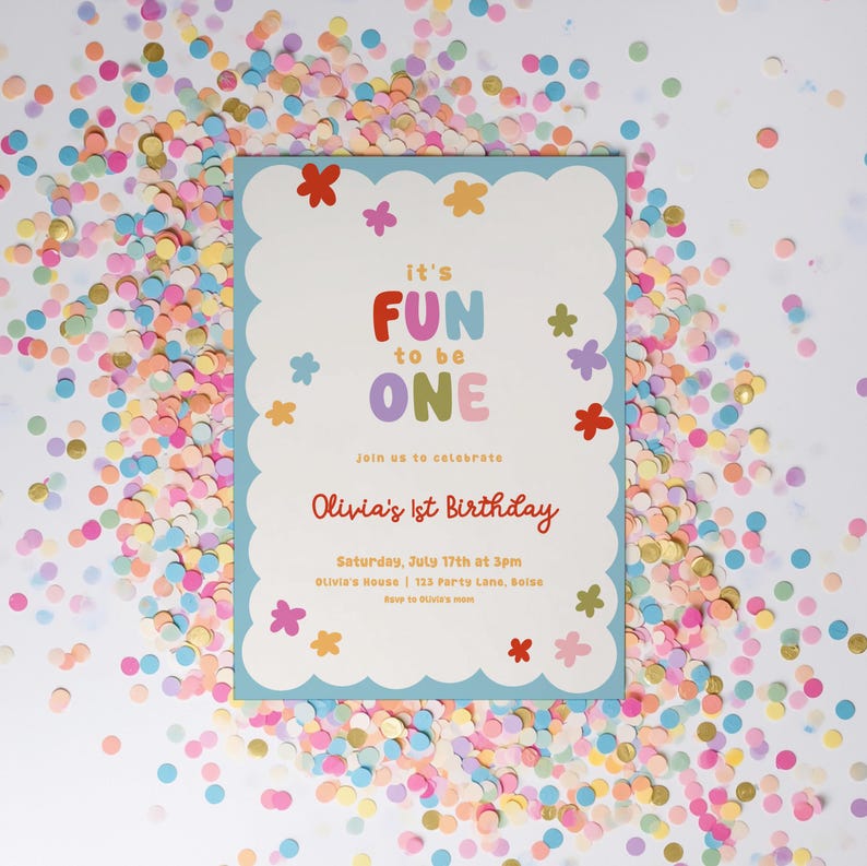 May include: A birthday invitation with a light blue scalloped border, featuring the text "it's FUN to be ONE" in colorful letters. The invitation includes details for Olivia's 1st birthday, surrounded by colorful confetti.