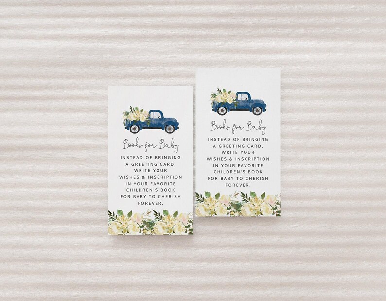 May include: Two blue and white cards with a watercolor illustration of a truck with flowers. The text on the cards reads "Books for Baby" and asks guests to write a message in a book instead of bringing a card.