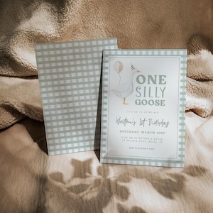 May include: An invitation with a light green and white gingham pattern, featuring the text "ONE SILLY GOOSE" and "Weston's 1st Birthday". The design includes a cartoon goose with a balloon. The invitation rests on a beige surface.