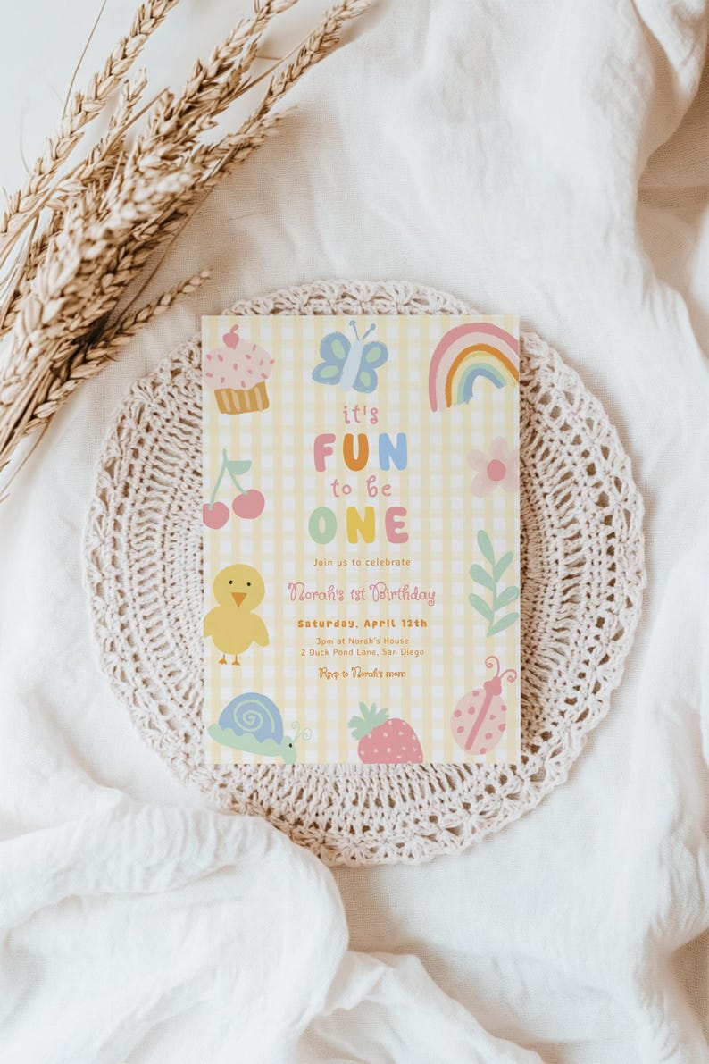May include: A pastel yellow birthday invitation with the text "it's FUN to be ONE" and illustrations of a cupcake, butterfly, rainbow, cherry, chick, snail, strawberry, and ladybug. The invitation is for Norah's 1st birthday.