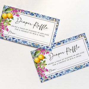 Puede incluir: Dos tarjetas blancas con bordes con patrones azules y dorados. Las tarjetas tienen el texto "Diaper Raffle" e instrucciones para traer un paquete de pa&ntilde;ales para tener la oportunidad de ganar un premio. Las tarjetas presentan una ilustraci&oacute;n de acuarela de limones y flores rosas.