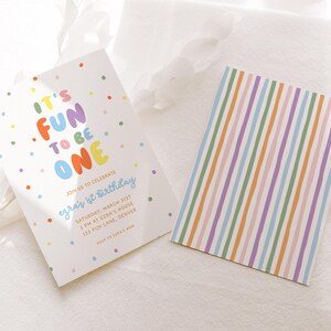 May include: Two white cards. One features the text "IT'S FUN TO BE ONE" in colorful letters, with confetti dots. The other card has vertical stripes in pastel colors. The text on the first card reads "Join us to celebrate Ezra's 1st Birthday".