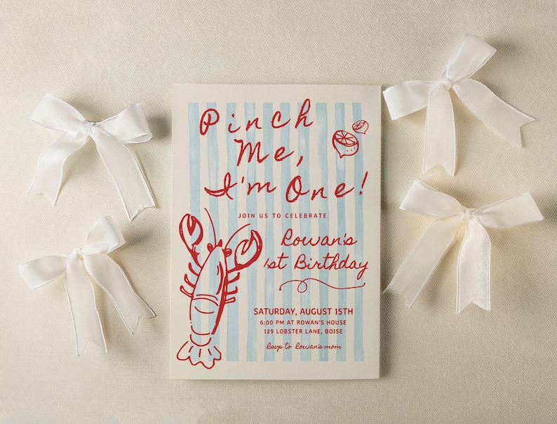 May include: An invitation for a first birthday celebration with the text "Pinch Me, I'm One!" in red script. The invitation features a red lobster illustration and is surrounded by white satin bows. The invitation is for Rowan's 1st Birthday.