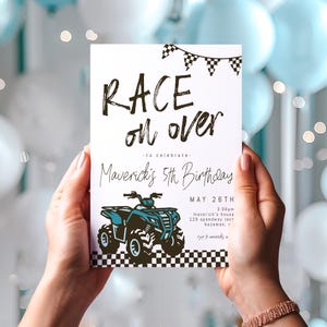 May include: A white invitation card with black and white checkered flags at the top. The text "RACE on over" is written in black with a brush stroke effect. The text "to celebrate - Maverick's 5th Birthday" is written in black cursive. The date "MAY 26TH" is written in black. The time "3:00pm" is written in black. The address "maverick's house 129 speedway lane bozeman, r" is written in black. The text "RSVP to maverick's mom" is written in black.
