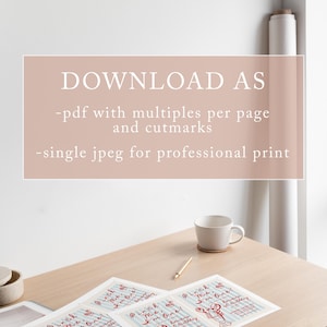 May include: A light wood table displays several invitation cards with a red lobster graphic and the text "Pinch Me, I'm One!" in red. The cards are for a birthday celebration. A white mug, a pencil, and a magazine are also on the table.