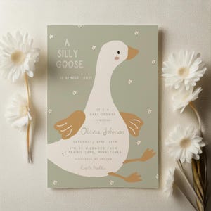 Puede incluir: Una invitación de baby shower verde y blanca con una ilustración de ganso de dibujos animados. El texto dice "A Silly Goose is Almost Loose. It's a Baby Shower - Honoring - Olivia Johnson. Saturday, April 12th, 2 PM at Wildwood Farm, 1 Prairie Lane, Minnetonka. Registered at Amazon. R.S.V.P. to Maillio."