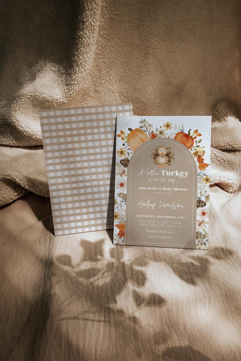Puede incluir: Una invitaci&oacute;n a un baby shower con una ilustraci&oacute;n de pavo y el texto "A little Turkey is on the way". La invitaci&oacute;n tiene un patr&oacute;n de cuadros beige y blanco en la parte posterior y est&aacute; decorada con calabazas y follaje de oto&ntilde;o.
