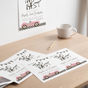 May include: Four white cards with black text that reads "Two Fast" and a pink race car graphic. The text also says "Hazel's 2nd Birthday".