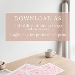 May include: Four pink printable invitations with a pink bow and a pink cake illustration. The text on the invitation reads "George's 2nd Birthday". The invitations are on a wooden table with a white mug and a gold pen.