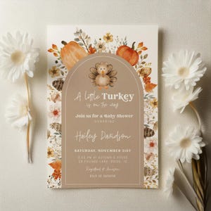 Puede incluir: Invitaci&oacute;n a baby shower con una ilustraci&oacute;n de pavo, calabazas y detalles florales. El texto dice "A Little Turkey is on the way" e invita a los invitados al baby shower de Hailey Davidson.
