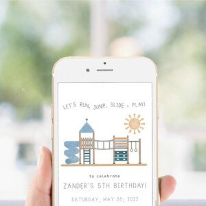 May include: A smartphone displaying a birthday invitation with a cartoon illustration of a playground. The text reads "Let's run, jump, slide, play!" and "Zander's 5th Birthday! Saturday, May 28, 2022".